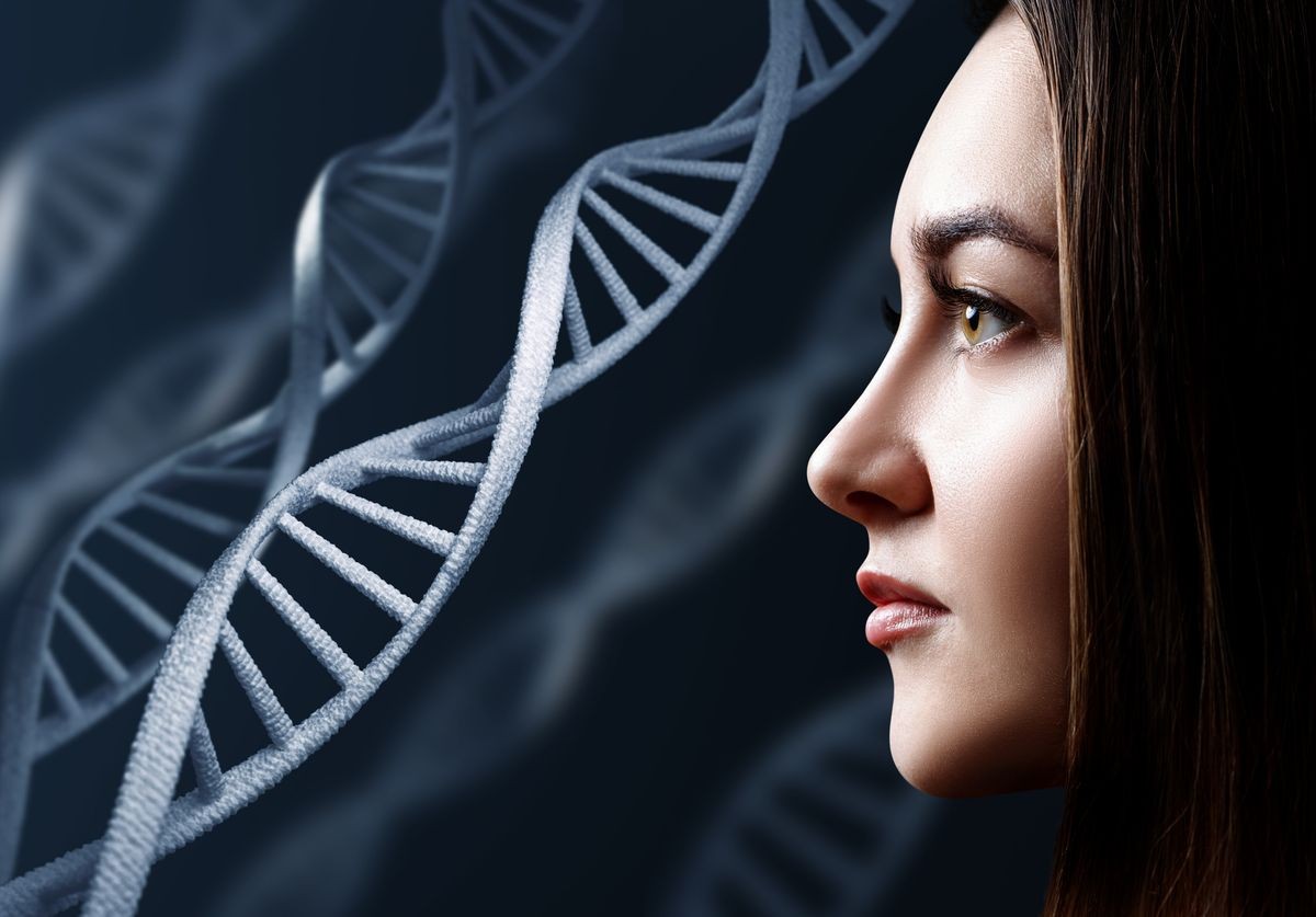 Portrait of sensual young woman among DNA chains. Over black background.